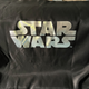 A black bag with the words Star Wars on it.